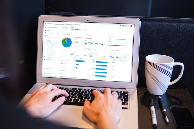 A person reviews data on MacBook - Myriam Jessier